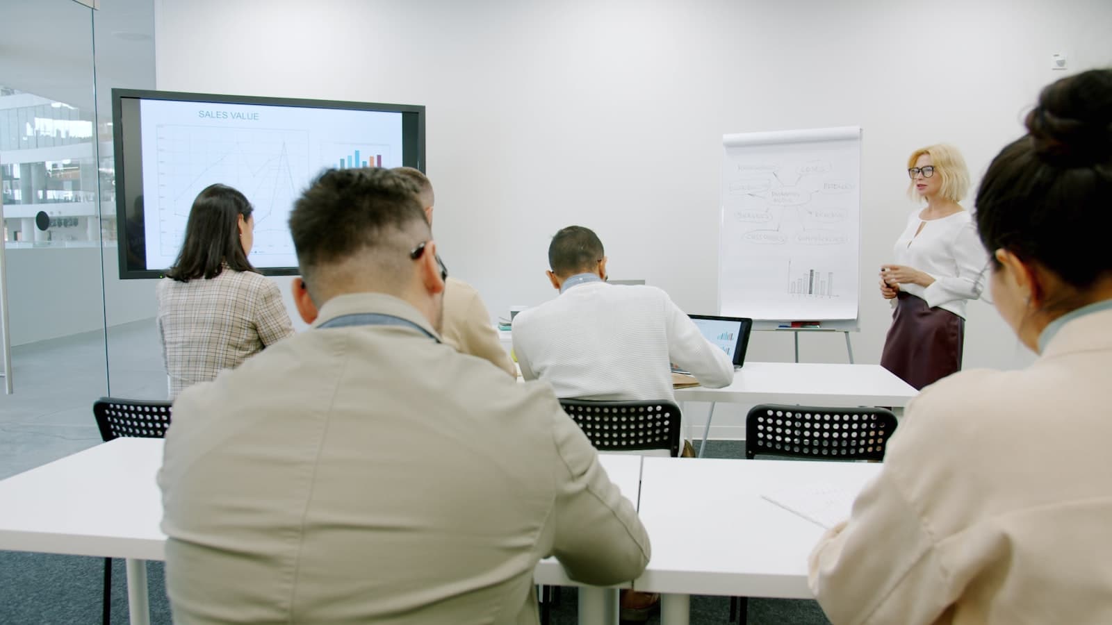 Business professional presenting security awareness training to employees in a modern office
