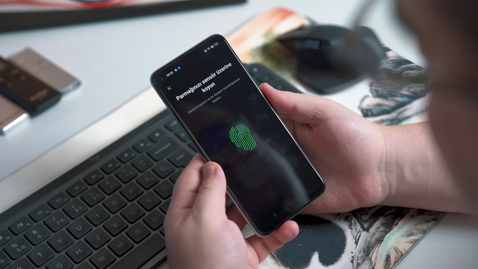 Person using a smartphone fingerprint sensor for secure identity authentication