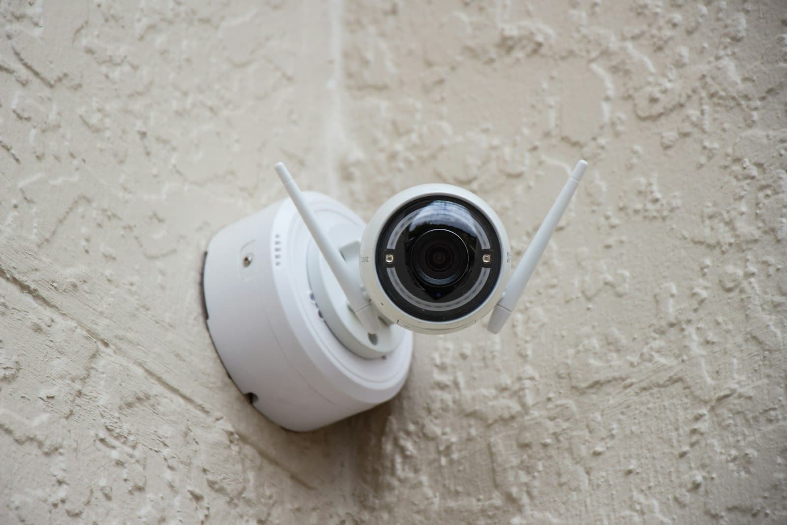 Single security surveillance camera mounted on a wall