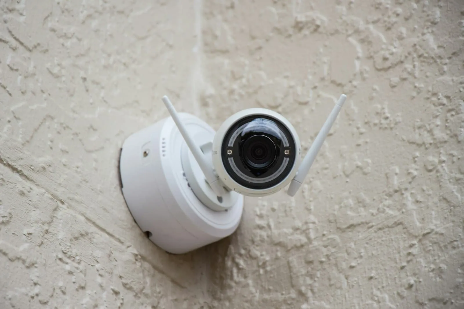 Single security surveillance camera mounted on a wall
